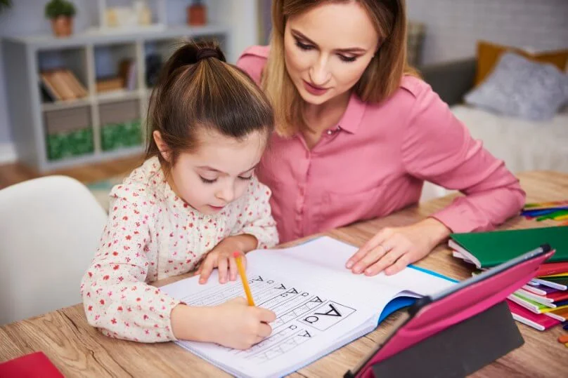 Parent helping teen with studies